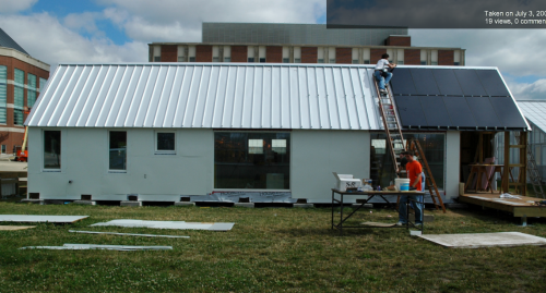 Students apply solar panels to the award-winning super-insulated Gable Home on the campus of the University of Illinois, Urbana-Champaign.